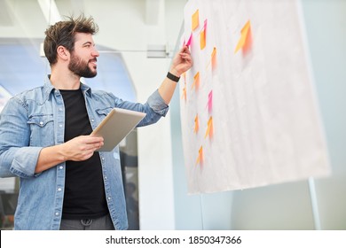 Business man evaluating ideas while brainstorming with sticky notes