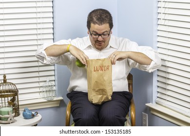 A Business Man Excited To Be Eating His Paper Sack Lunch.