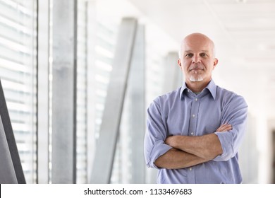 Business Man Facing The Camera With Arms Crossed.