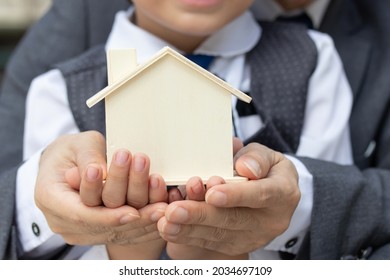 Business man father teach child little son boy  manage financial to save money and spend  with economy plan budget, Father and kid thrift coins in model house.
