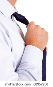 Business man fixing his tie, isolated over white