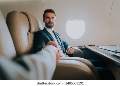 Business Man Flying On A Private Jet. Working Onboard Of The Airplane. Successfull Businessmen Lifestyle. Concept About Traders, Affiliate Marketing And Sales People