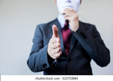 Business Man Giving Dishonest Handshake Hiding In The Mask - Business Fraud And Hypocrite Agreement