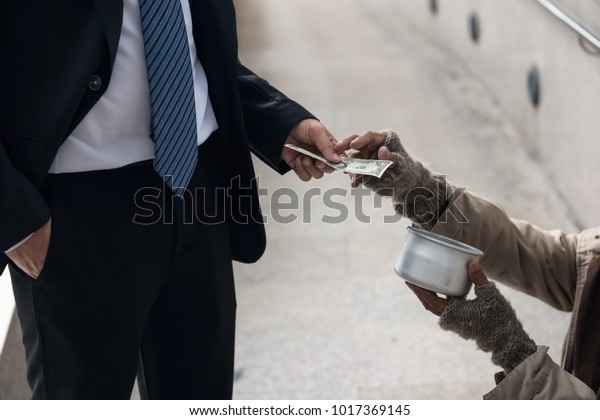 Business Man Giving One Dollar Bill Stock Photo (Edit Now) 1017369145