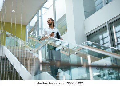 Business Man Going To Work In Office Building. Male Worker With Folder Going Up Stairs In Modern Office Interior. High Resolution