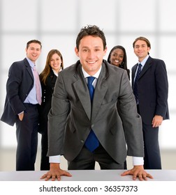 Business man with a group behind him at an office - Shutterstock ID 36357373