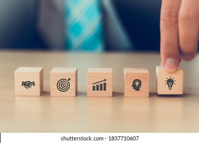 Business Man Hand Arranging Wood Block With Icon Strategy Of Business, Action Plan, Goal, Idea, Strategic, Partner With Copy Space