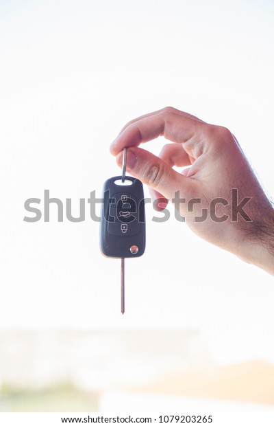 business man hand with a car key. Isolated on\
white background