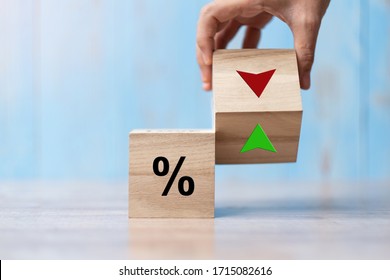 business man Hand change wood cube block with percentage to UP and Down arrow symbol icon. Interest rate, stocks, financial, ranking, mortgage rates and Cut loss concept