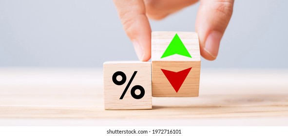 business man Hand change wood cube block with percentage to UP and Down arrow symbol icon. Interest rate, stocks, financial, ranking, mortgage rates and Cut loss concept - Shutterstock ID 1972716101