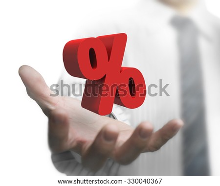 Business man hand holding 3D red percentage sign.