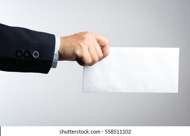 Business man hand holding envelope on white background