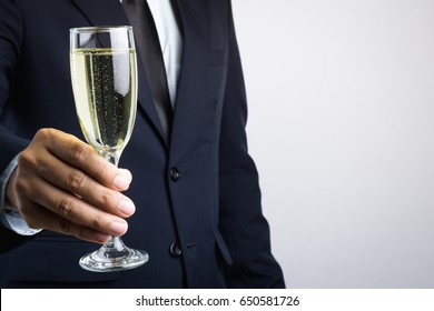 Business Man Hand Holding Glass Of Champagne For Celebration On White Background