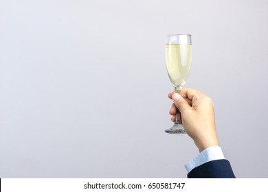 Business Man Hand Holding Glass Of Champagne For Celebration On White Background