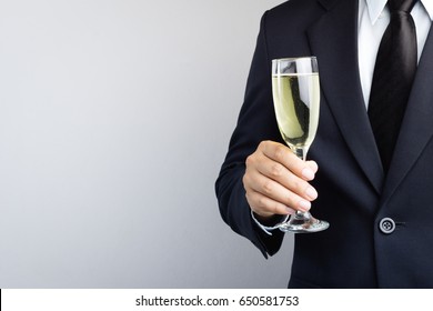 Business Man Hand Holding Glass Of Champagne For Celebration On White Background