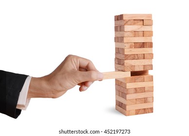 Business Man Hand Pick And Put Last Piece Block Of The Wood Puzzle, Abstract Business Concept Of Last Important Solution In Strategy. 