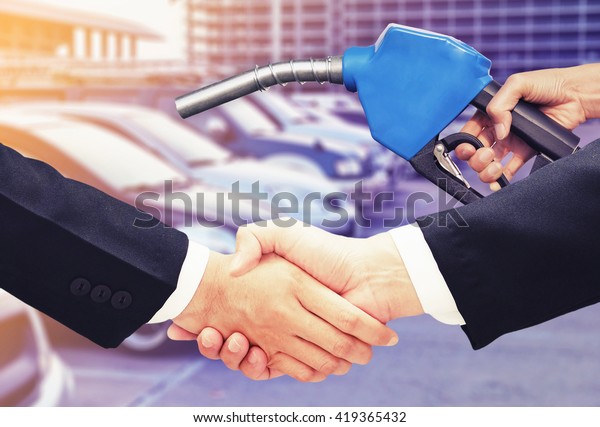 business man\
hand shake , deal oil concept\
background
