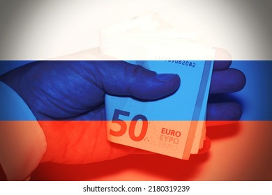 Business Man Hand While Handing Money With The Russian Flag As Background, Concept Of Corruption . 