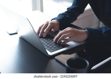 Business Man Hands Typing On Laptop Computer Keyboard, Searching Information, Surfing The Internet On Dark Office Desk, Distance Job, Online Working, Business And Technology Concept