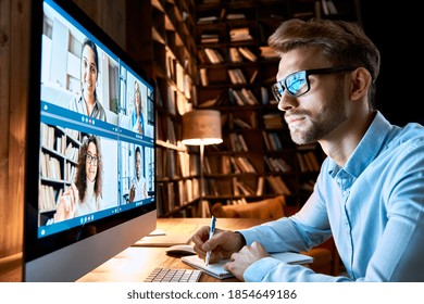 Business man having virtual team meeting on video conference call using computer. Social distance employee working from home office talking to diverse colleagues in remote videoconference online chat. - Powered by Shutterstock