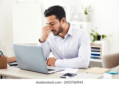 Business man, headache and laptop in office with stock market crash and financial problem. Stress, anxiety and burnout of a banker and professional with accounting risk and audit report or debt - Powered by Shutterstock