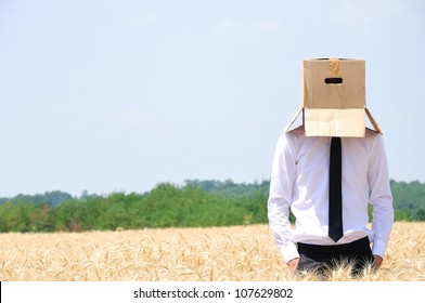 Business man hiding face with box