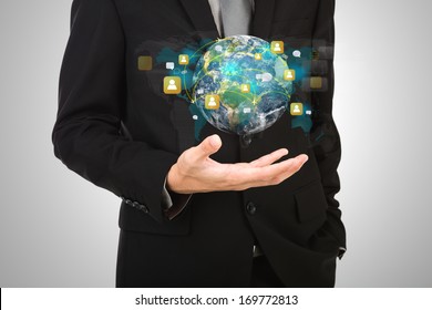 Business man hold earth of social network (Elements of this image furnished by NASA)