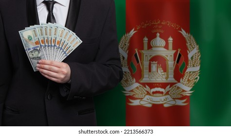 Business Man Holding 100 Us Dollar Bills Against Flag Of Afghanistan Background Closeup 