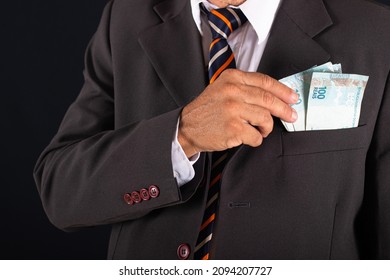 Business Man Holding Brazilian Money In Hand In His Suit Pocket.