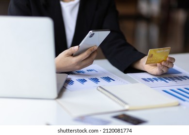 Business man holding credit card and using mobile phone. Check credit card limit via mobile internet. Conduct online financial transactions concept. Online shopping. - Shutterstock ID 2120081774