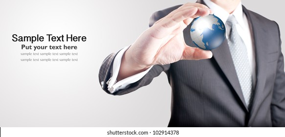 Business man holding digital globe with blank space for text on left
