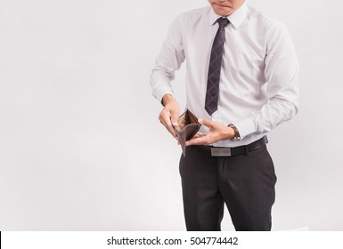 Business man holding an empty wallet in his hands.