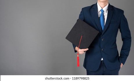business man is holding graduation hat, business education concept 