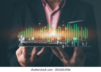 A Business Man Holding The Green Board Electronic Chip, Computer Graphic Light, Sound Wave Audio Connection Concept 