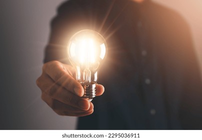 Business man holding light bulb. New idea, innovation technology and creative concept.