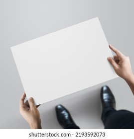 Business Man Holding Paper For Map At Top View Walkway Background.