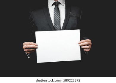 A Business Man Holding A Paper. Studio Shot