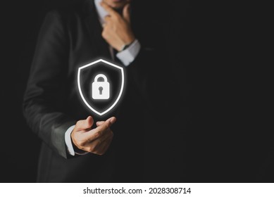 Business Man Holding A Protective Shield Icon
Cybersecurity Keeps Your Data Safe Concept.
Daily Use Of The Internet Is At Risk Of Identity Theft.