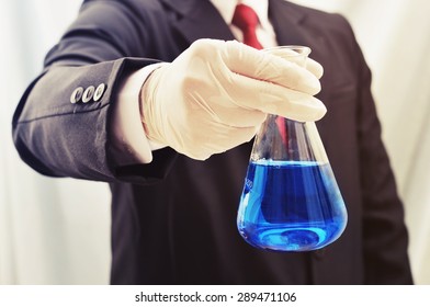 Business Man Holding Science Flask