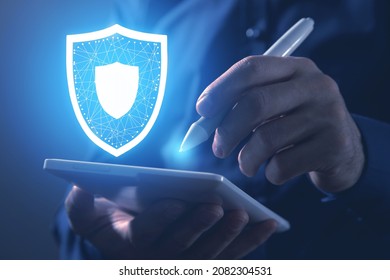 Business Man Holding Shield And Using Tablet. Protection