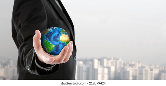 Business man holding the small world in his hand (Elements of this image furnished by NASA) - Shutterstock ID 212079424
