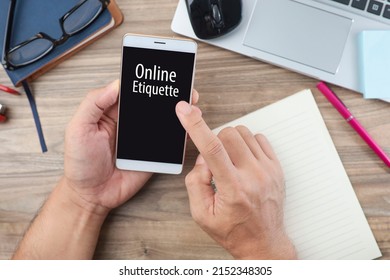 A Business Man Holding A Smartphone With ONLINE ETIQUETTE Message On The Screen. Online Etiquette Concept. 