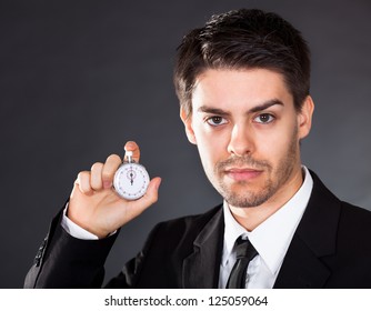 Business Man Holding Stop Watch In His Hand