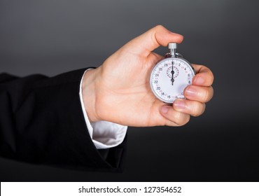 Business Man Holding Stop Watch In His Hand