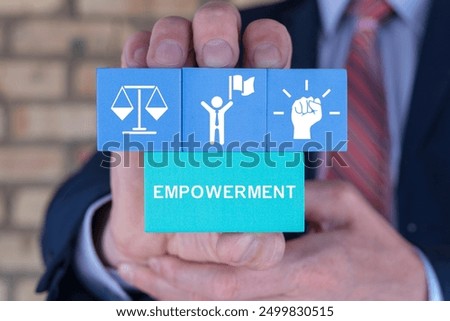 Business man holding styrofoam blocks with icons sees word: EMPOWERMENT. Culture of empowerment concept. Employee empowerment. Empower Enable Authorize Liberate Power.