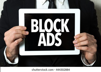 Business Man Holding A Tablet With The Text: Block Ads