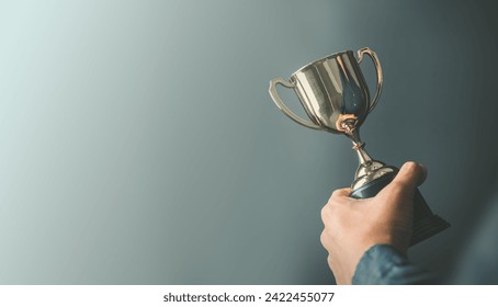 business man holding a trophy from his success. Business reward for your effort for success in your life - Powered by Shutterstock