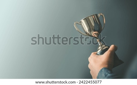 business man holding a trophy from his success. Business reward for your effort for success in your life