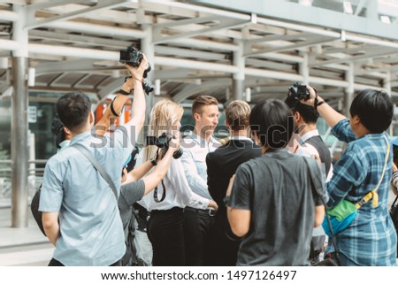 business man important press release surrounded scramble with reporters newspaper journalist photographer