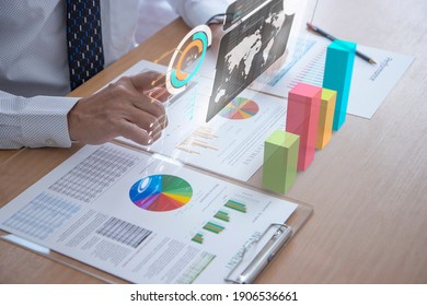 Business man interacting touching on a futuristic augmented reality screen while analysing or reviewing on business performace and investment analysis or return on investment, ROI.